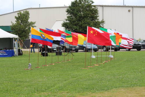 Flags of various countries on poles in field at the Dayton World Soccer Games.